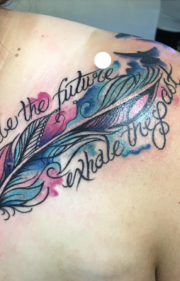 Watercolor feather with script reading inhale the future, exhale the past